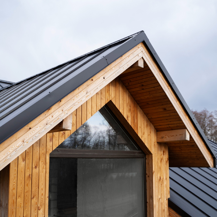 Toiture moderne avec habillage soigné sur maison en bois, montrant une couverture propre et des finitions nettes